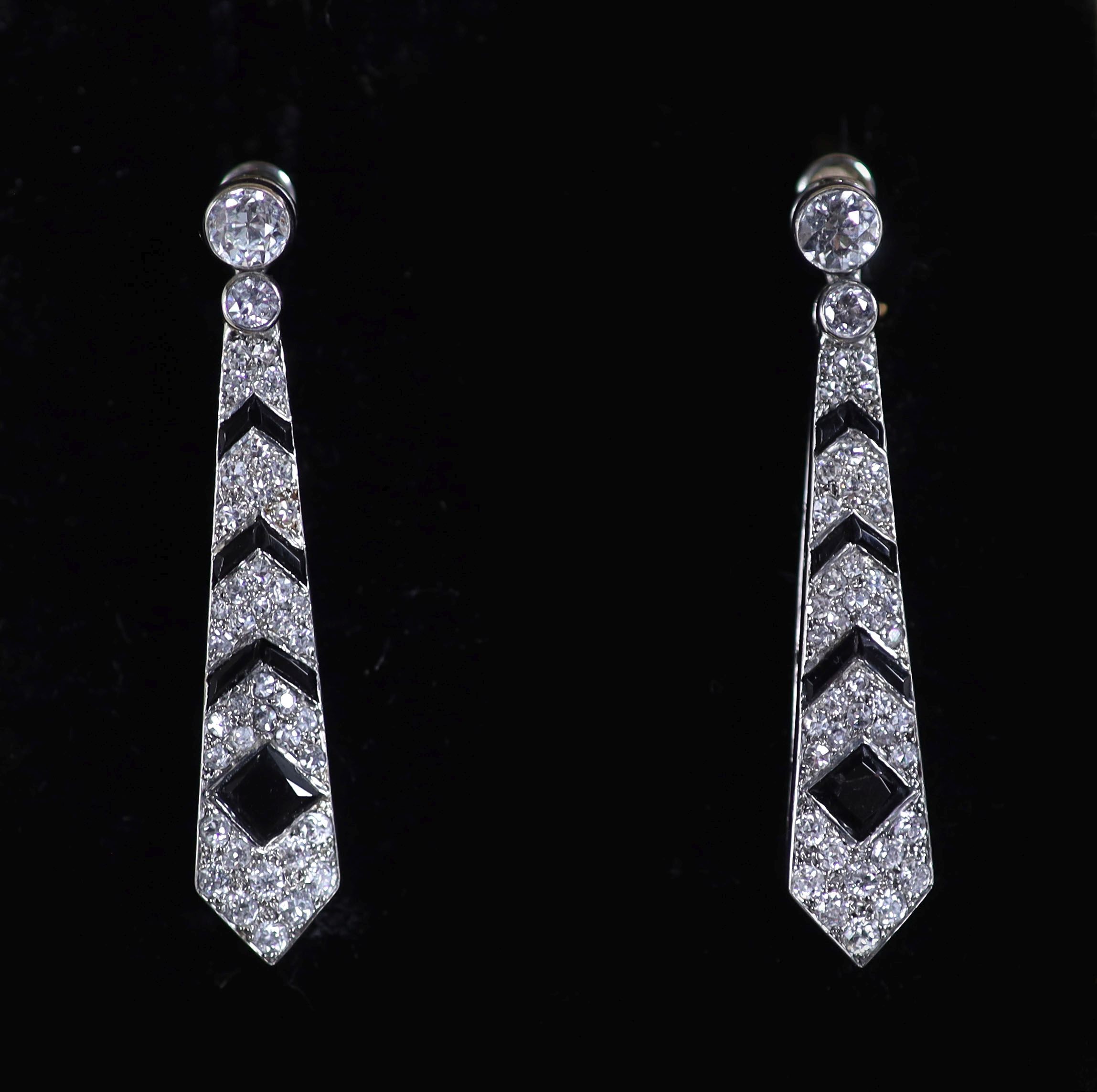 A pair of Cartier Art Deco French platinum, black onyx and diamond set tapering drop earrings, (converted)